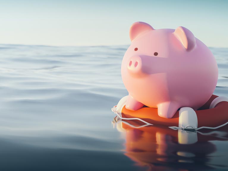 A piggy bank floating on a life saver